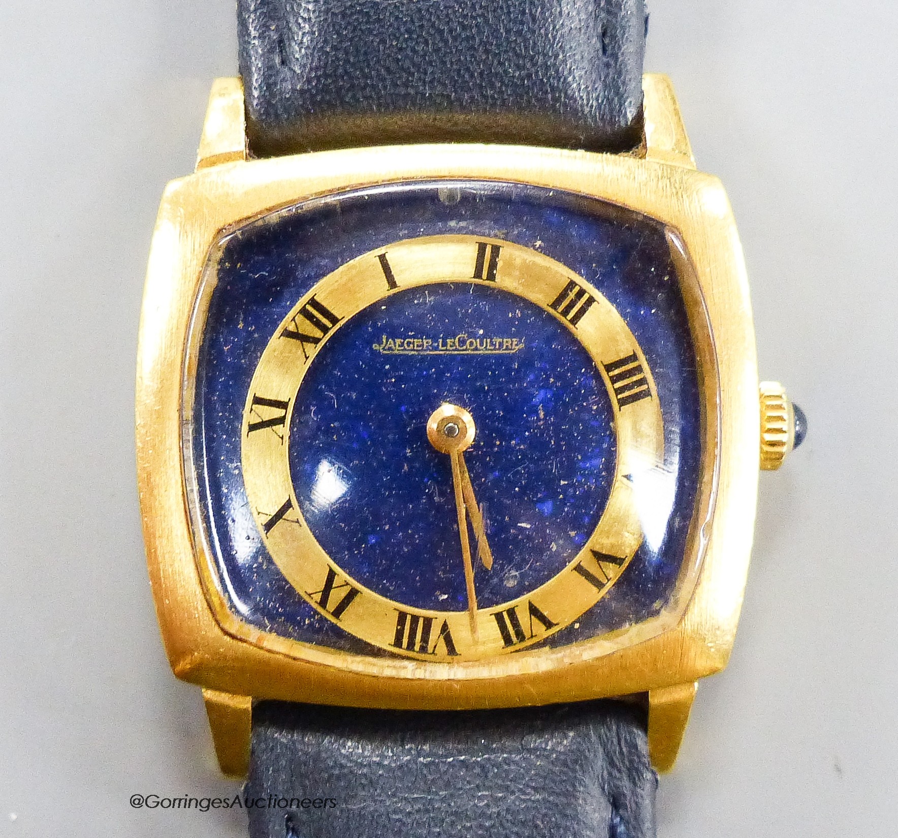 A lady's? 18k yellow metal Jaeger LeCoultre manual wind dress wrist watch with lapis lazuli dial (with loose Roman chapter ring), case diameter 29mm, gross weight29.7 grams.